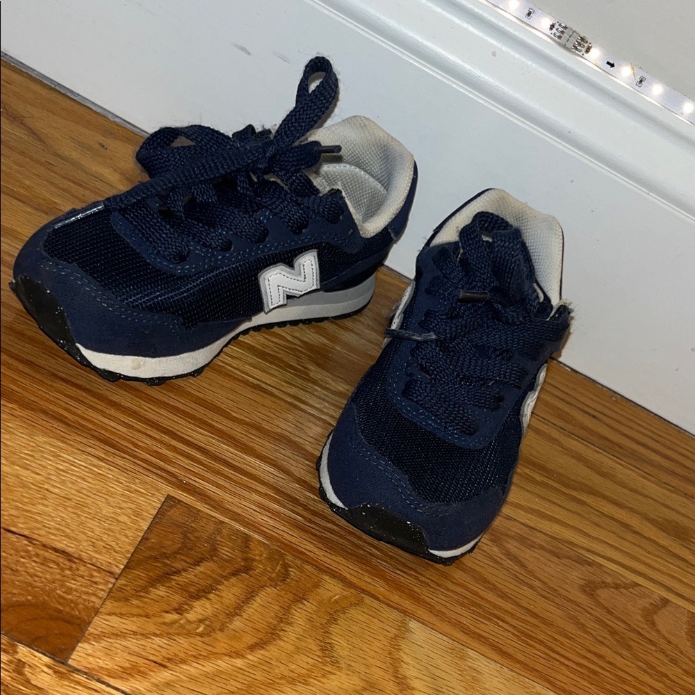 Navy Blue New Balances, 11C, slightly worn, in good condition.